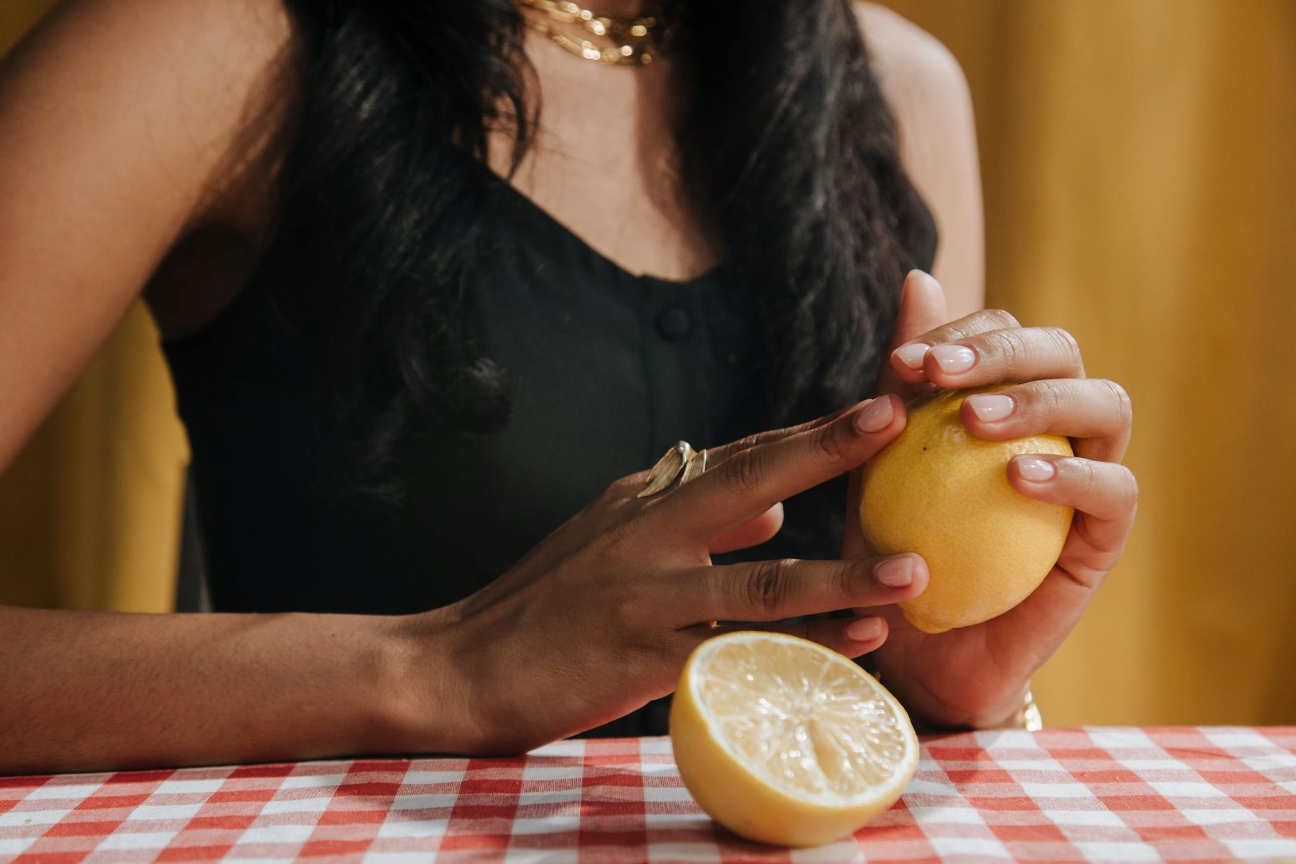 Woman holding two silicone vibrators contemplatively