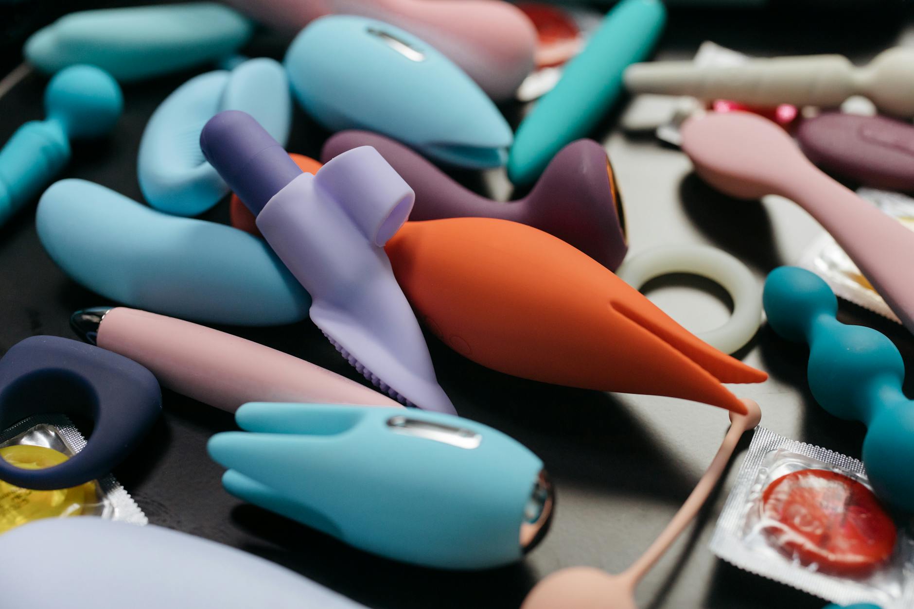 An array of vibrant adult toys including clitoral vibrators in close-up view