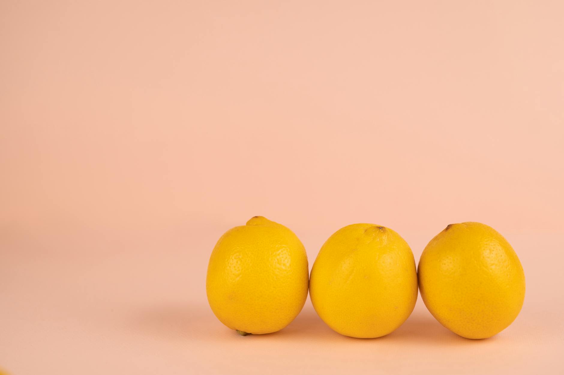 Fresh yellow lemons on pastel background